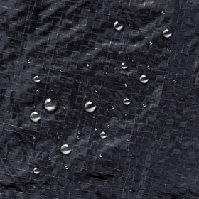 Winter Block blue cover on pool demonstrates weatherproof protection.