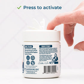 Wondercide fruit fly trap on kitchen counter captures flies safely.