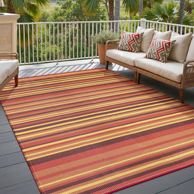 WondRg outdoor straw rug with red-orange stripes on patio; UV-resistant and color-stable.