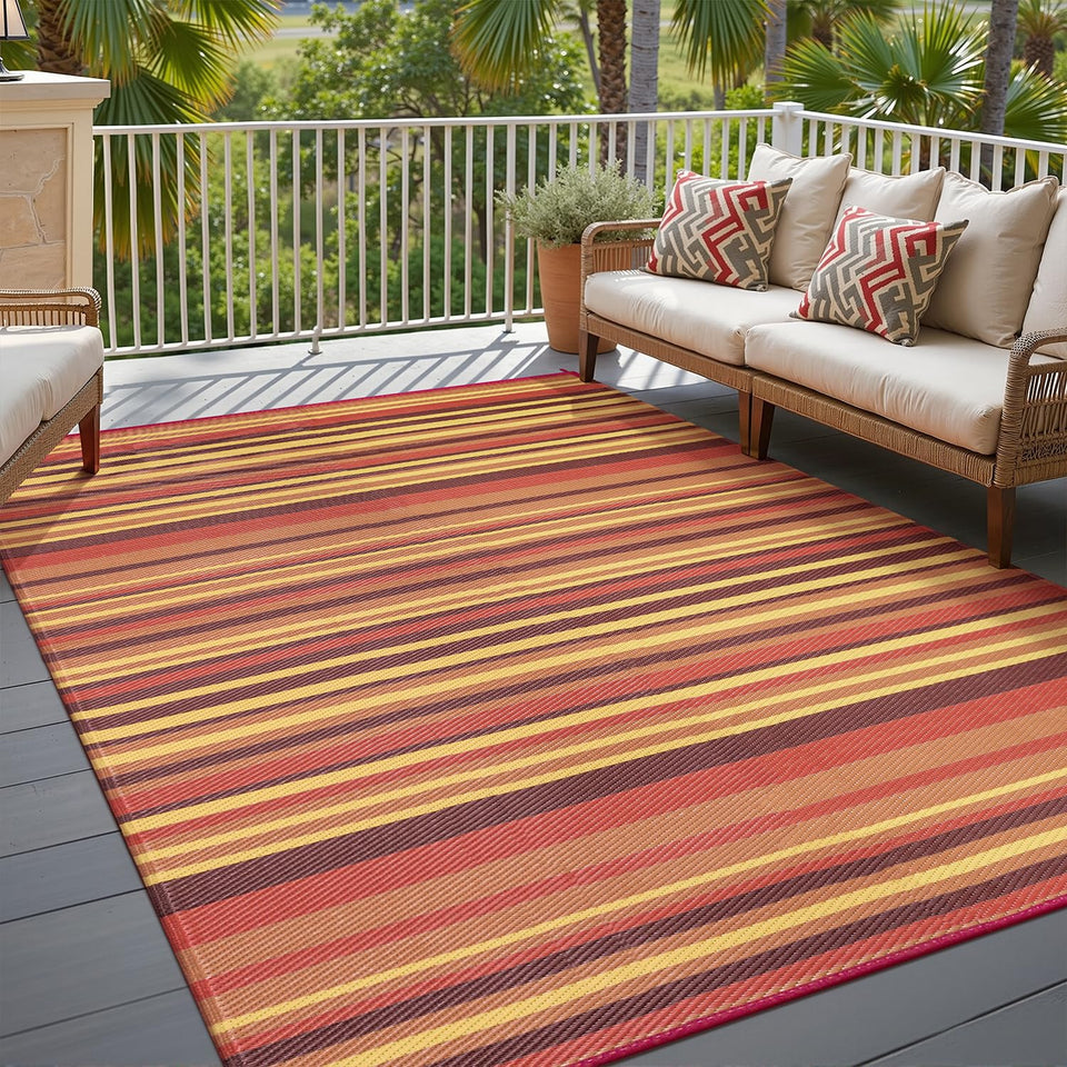 WondRg outdoor straw rug with red-orange stripes on patio; UV-resistant and color-stable.