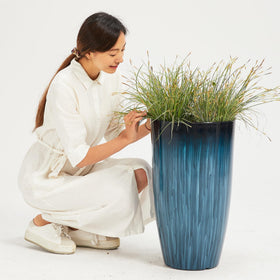 Worth Garden front porch decor in glossy blue creates welcoming curb appeal.