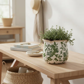 Xiaan Jiaju Tuscan ceramic plant pot pairs with foliage for vibrant displays.