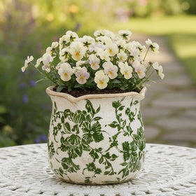 Xiaan Jiaju Tuscan ceramic plant pot with vintage glaze adds rustic charm.