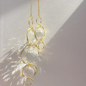 Yajuo crystal suncatcher with a sturdy metal ring for hanging.