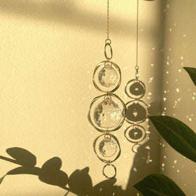 Yajuo prism suncatcher projects sunlight into a vivid wall rainbow.