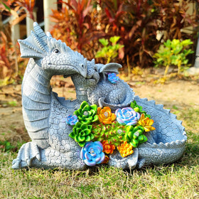Yardancer Dragon solar statue side view glowing softly in nighttime.