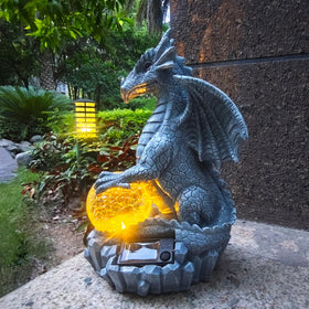 Yardancer dragon solar garden statue outdoors with glowing orb for elegant dusk ambiance