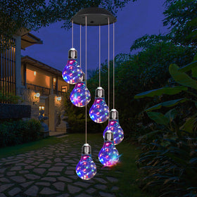 YHmall colorful solar wind chimes outside illuminate at dusk for festive outdoor ambiance.