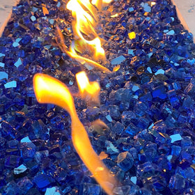 YISZM cobalt blue fire glass on an outdoor fire table creates ambient glow.
