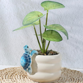Yolev climbing tortoise statue brings whimsy to planters.