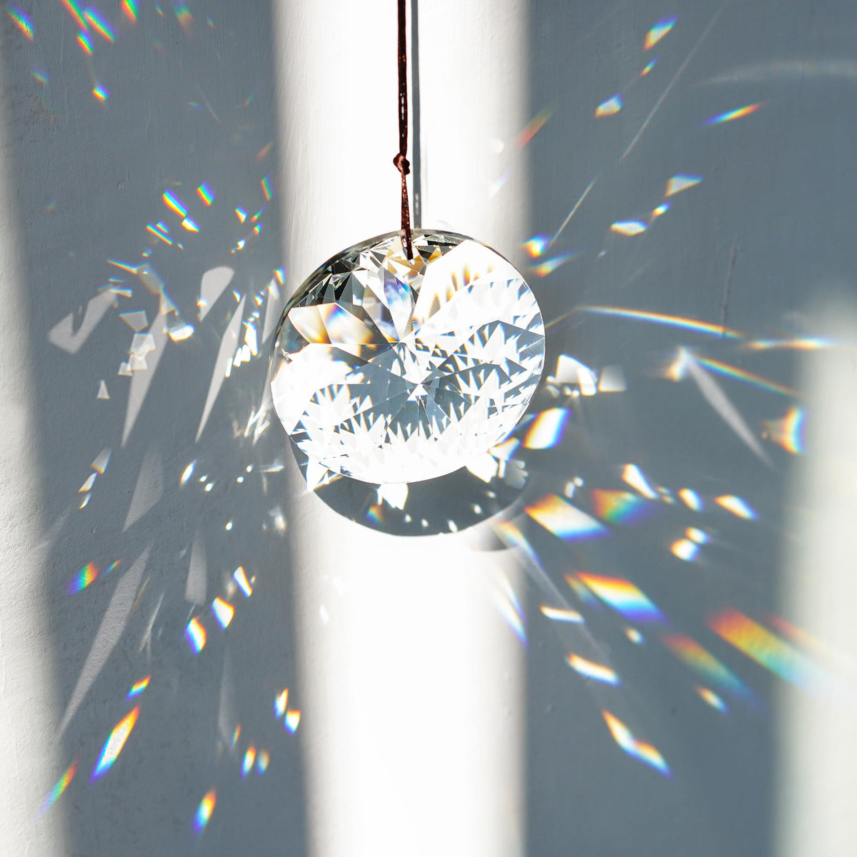YU FENG Bauhinia faceted crystal prism window reflecting indoor light