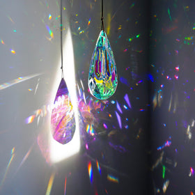 YU FENG faceted rainbow maker crystal pendant brightening a doorway.