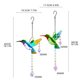 YU FENG hummingbird suncatcher in outdoor garden casting reflections on greenery.