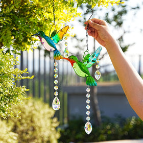 YU FENG stained glass hummingbird ornament sparkling under afternoon sun.