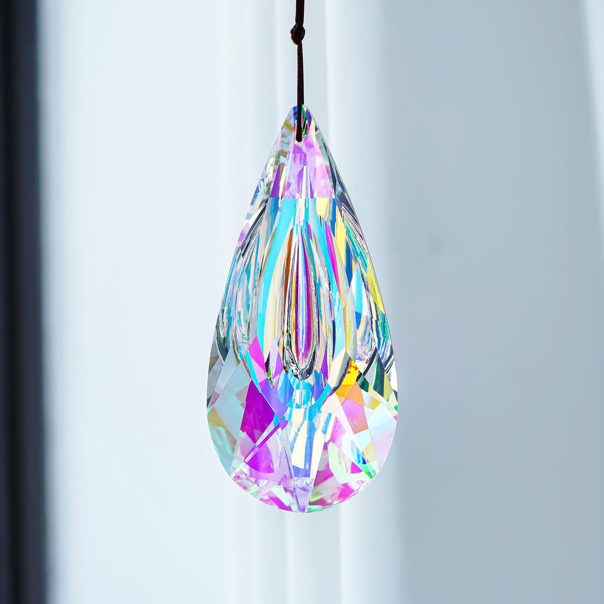 YU FENG crystal suncatcher on Christmas tree adds sparkle.