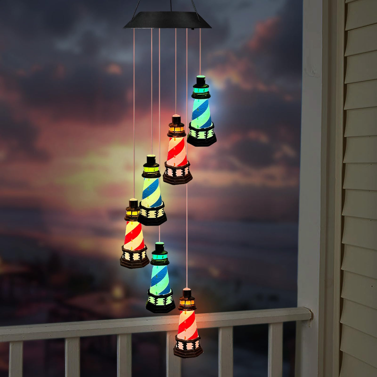 YY Gardenia solar lighthouse wind chimes lit for outdoor ambience.