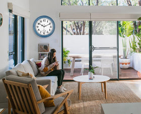 Zyzamay porch clock on outdoor wall, adds retro charm.